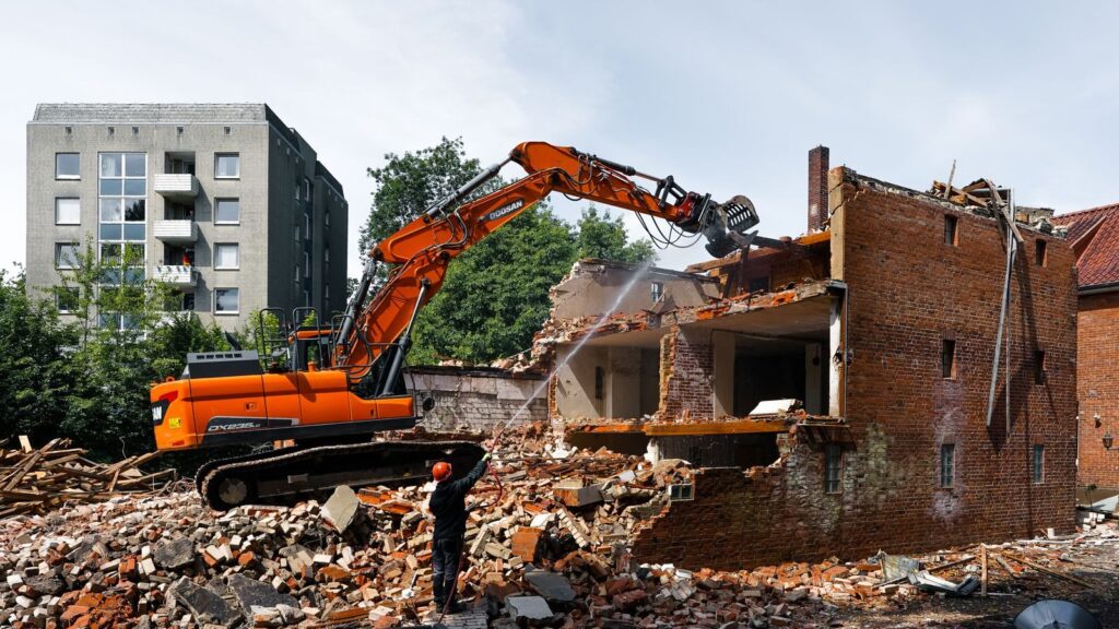 An excavator demolishing an old building in Geesthacht, Germany.