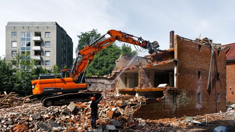 An excavator demolishing an old building in Geesthacht, Germany.